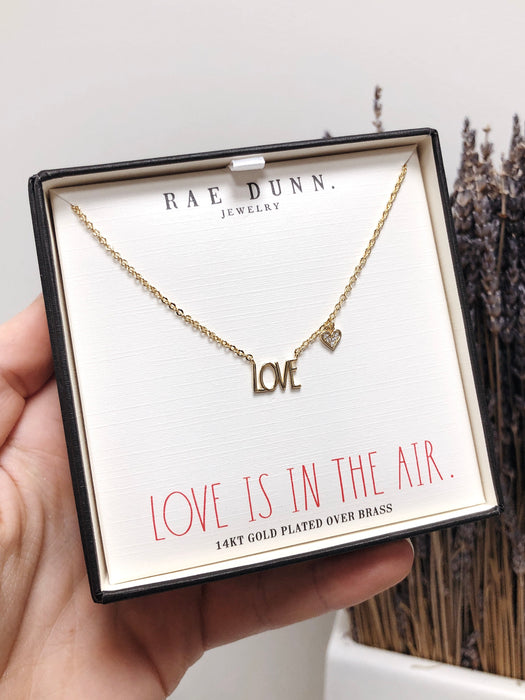 Rae Dunn LOVE station necklace in yellow gold plated brass with a cubic zirconia heart charm